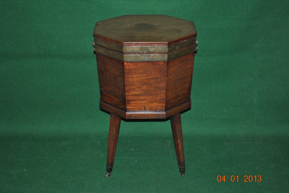 A mahogany brass bound hexagonal cellarette standing on square tapered legs ending in brass