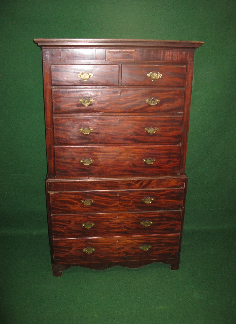 A mahogany chest on chest with moulded cornice over two short and six long drawers with brass