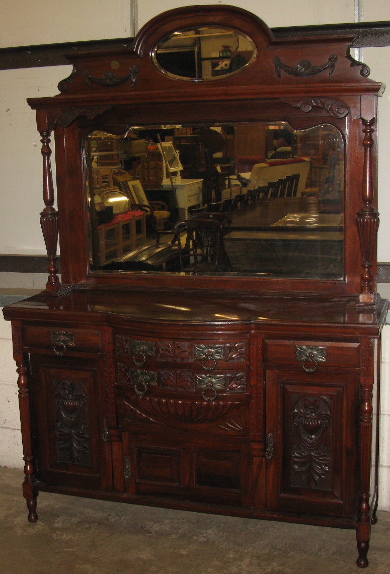 A walnut mirror backed sideboard, the top having small raised back with mirror on a shelf