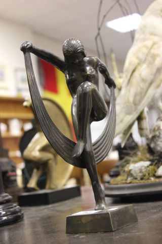 An Art Deco Style Bronze Figure of a Girl holding a Crescent Moon