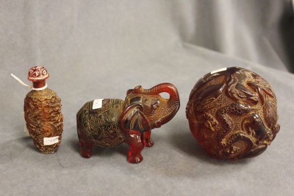 Three items of Amber Style Carved Items - Elephant, Zodiac Ball and Snuff Bottle