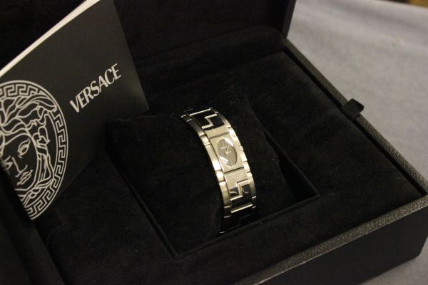 A Boxed Versace Ladies Wristwatch together with an after sales booklet