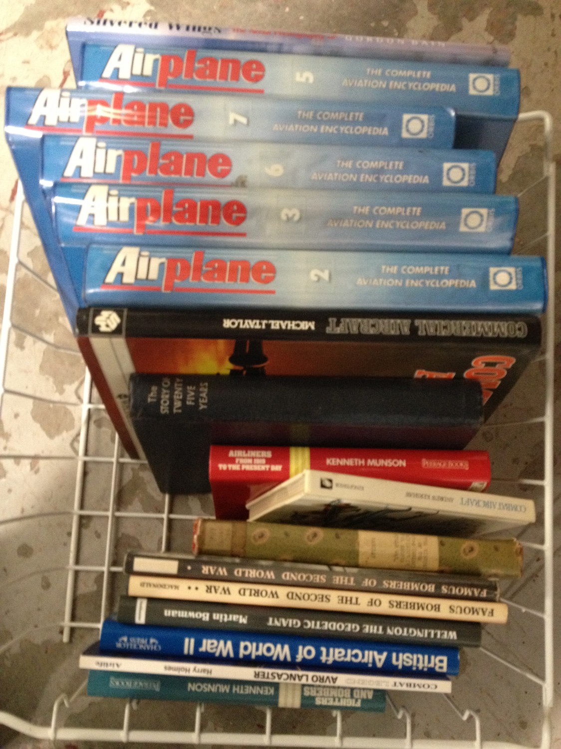 Basket containing hardback books relating to aviation