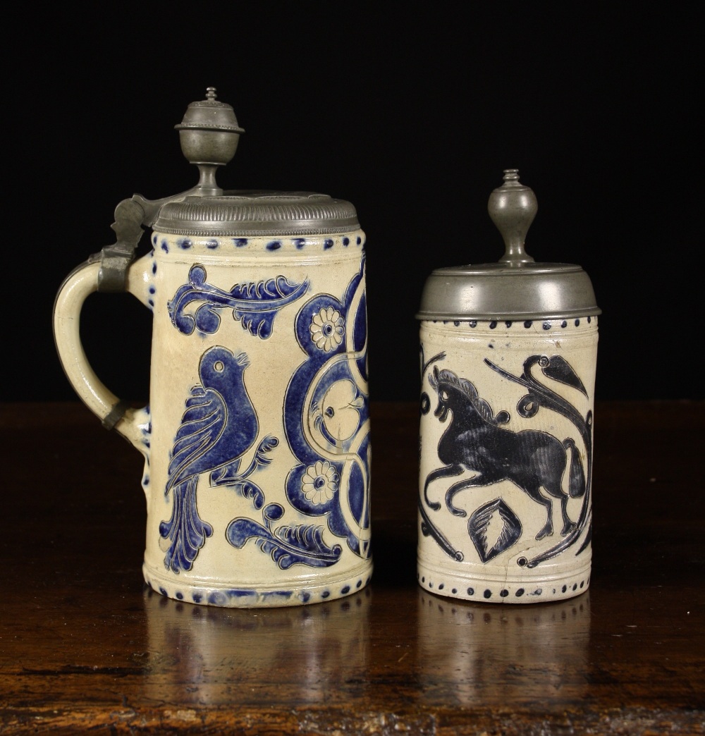 Two Westerwald Blue & Grey Stoneware Flagons with hinged pewter lids and finialed thumb pieces.  One
