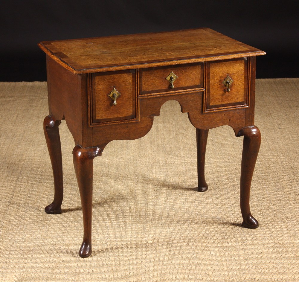 An 18th Century Oak Lowboy Cross-banded in mahogany.  The top having a moulded edge above three