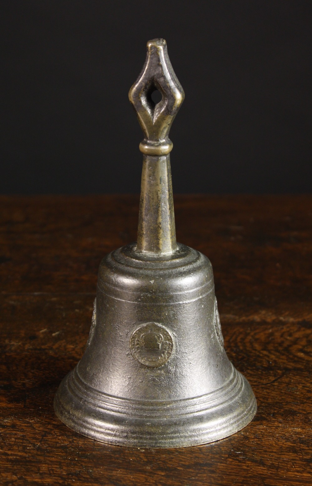 A 16th Century Netherlandish Bronze Hand Bell. The frieze cast with oval & round medallions; one