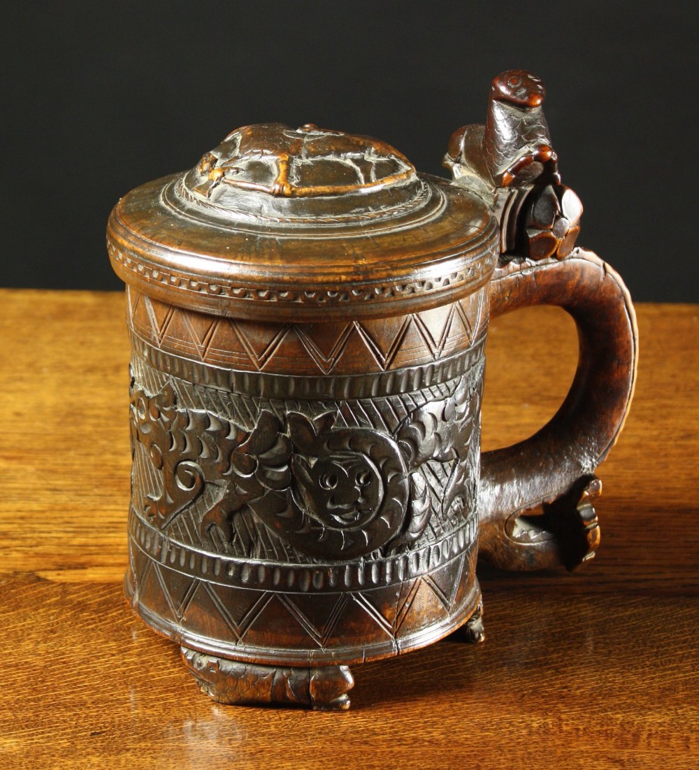 A Fine Early 19th Century Scandinavian Carved Peg Tankard.  The domed lid carved in relief with a