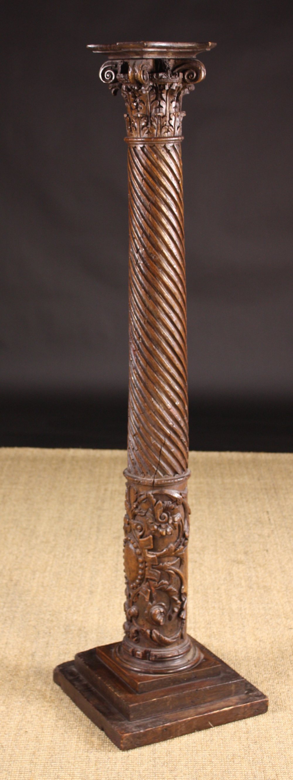 A 16th Century French Carved Walnut Column.  The Corinthian style capital above a wrythen fluted