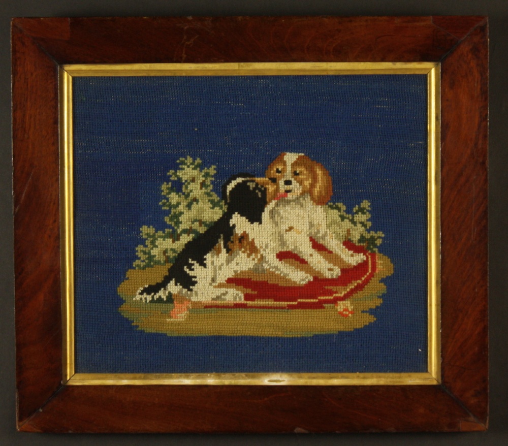 A Mid 19th Century Berlin Woolwork of King Charles Spaniel Pups on a blue ground, 11 ins x 13 ins (