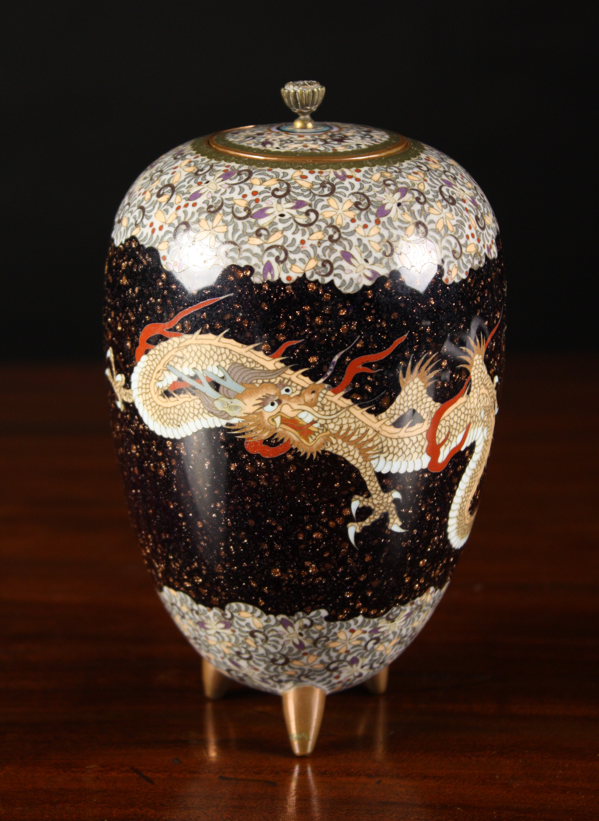 A Fine Quality Cloisonné Vase with cover.  The ovoid body raised on three small feet and decorated