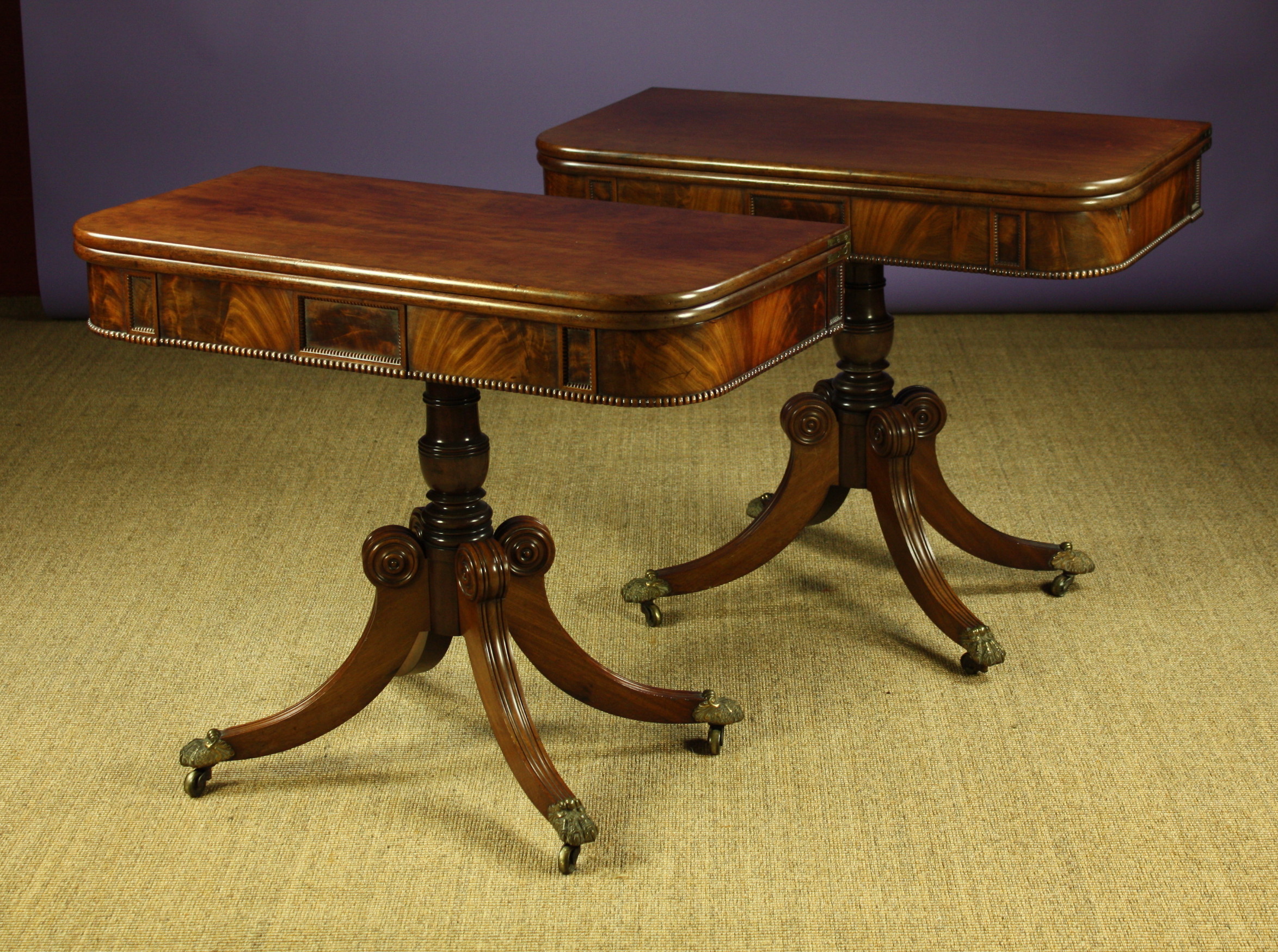 A Pair of Regency Plum-Pudding Mahogany Tea Tables.  The rotating fold over tops above frieze box