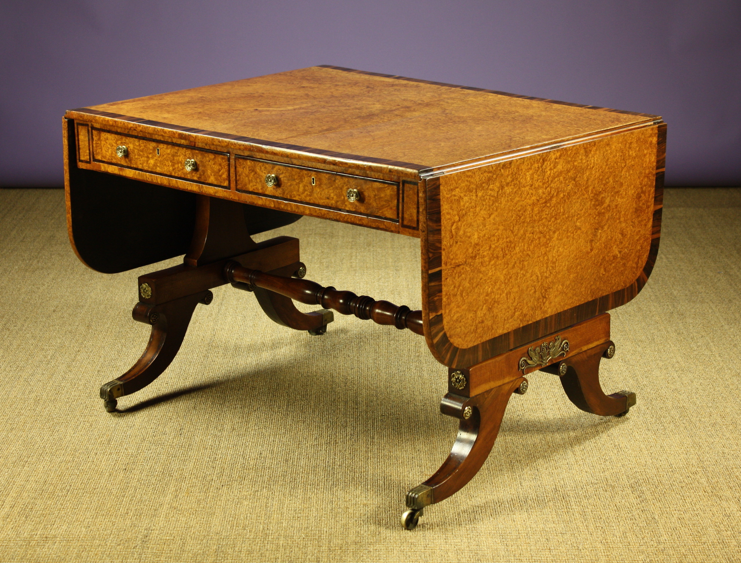 A Fine Regency Amboyna & Rosewood Cross-banded Sofa Table.  The frieze having two drawers on one