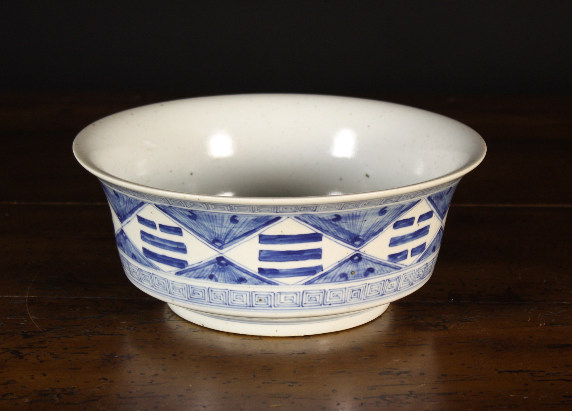 A Chinese Blue & White Bowl.  The centre panel decorated with bats flitting amongst peonies and