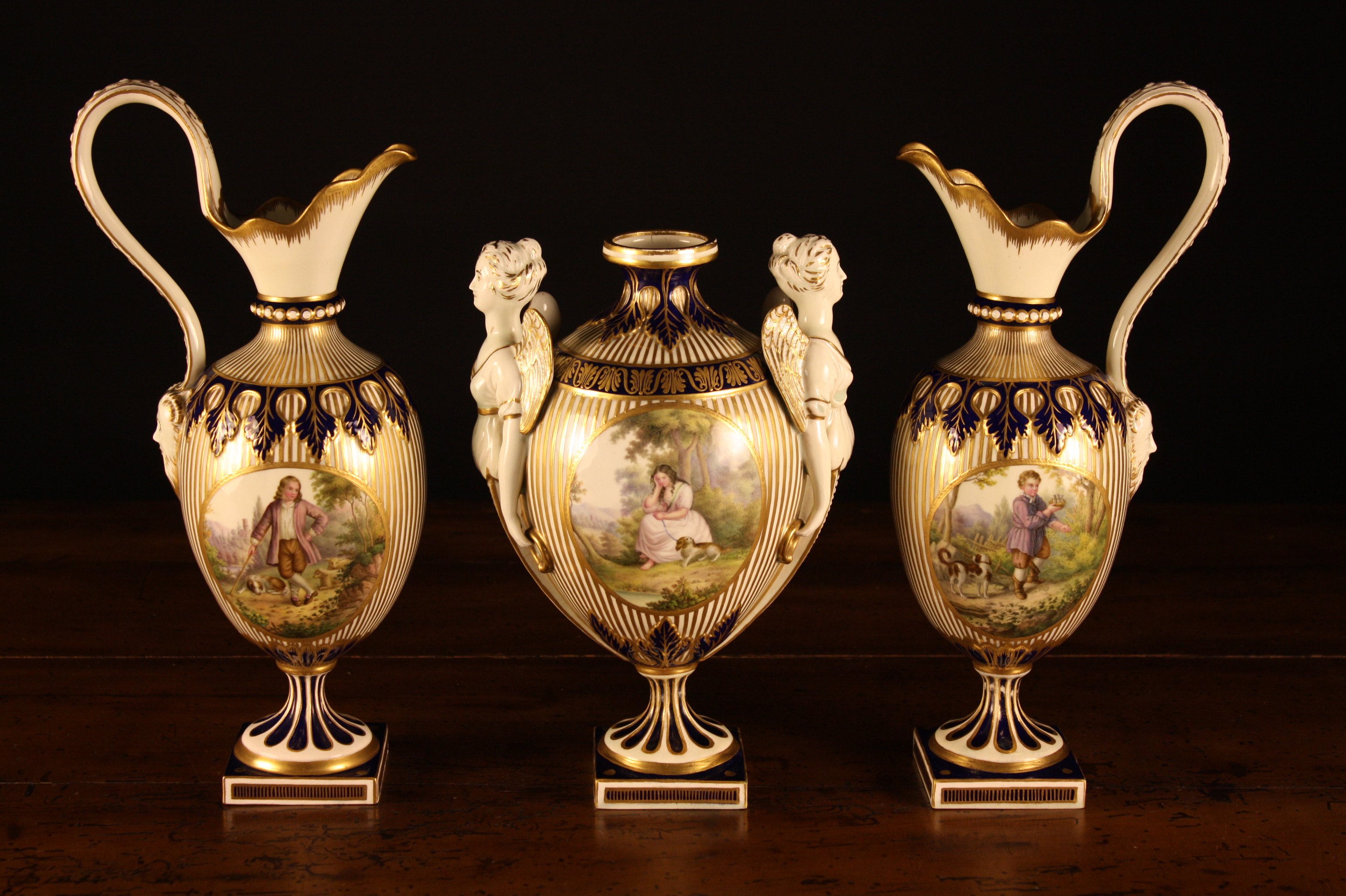 A 19th Century Porcelain Garniture Set comprising of an urn and two ewers (A/F).  The ovoid bodies