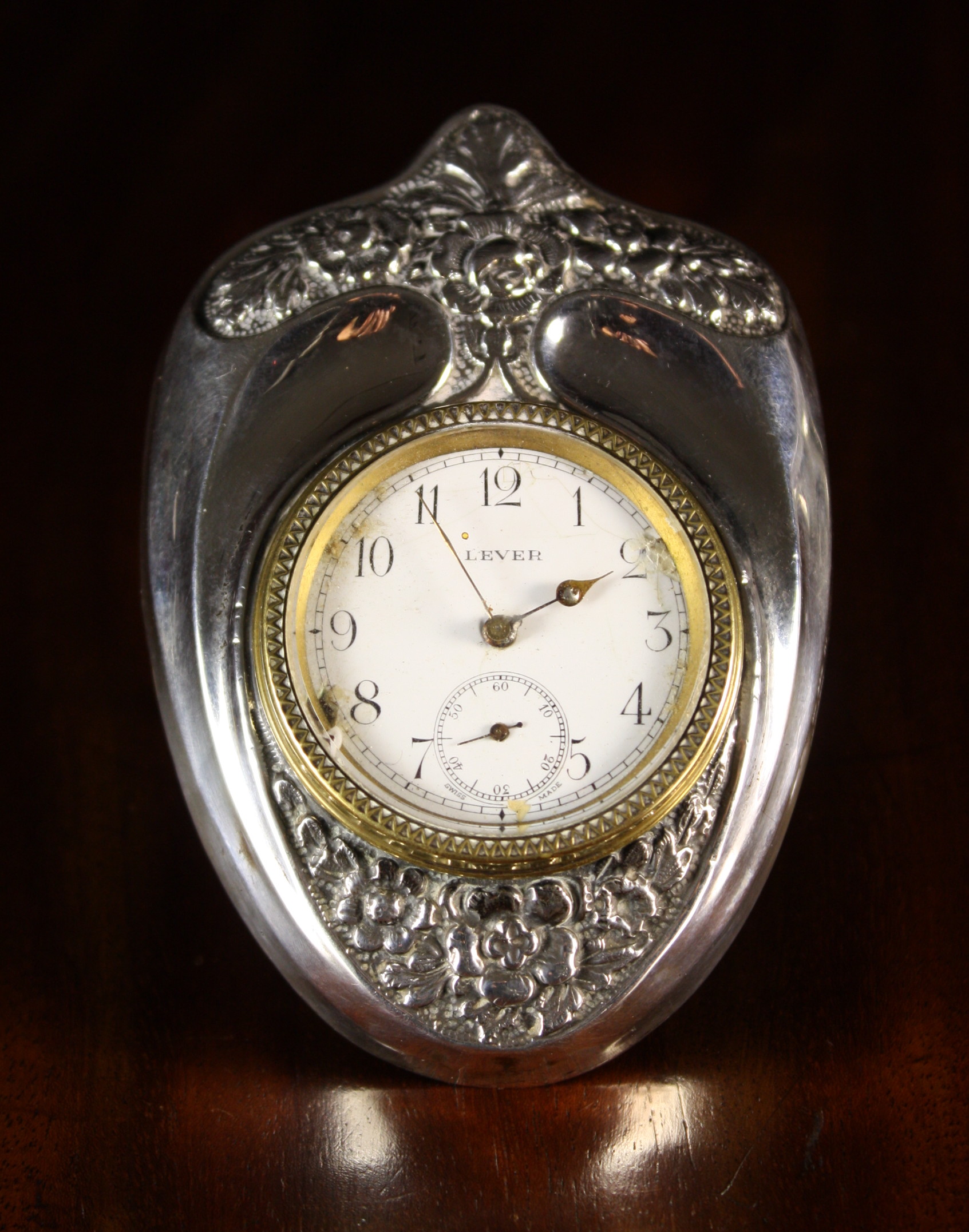 An Attractive Silver Lever Ancrel Clock in a Shield Design Stand. Marked Birmingham 1900, model ref: