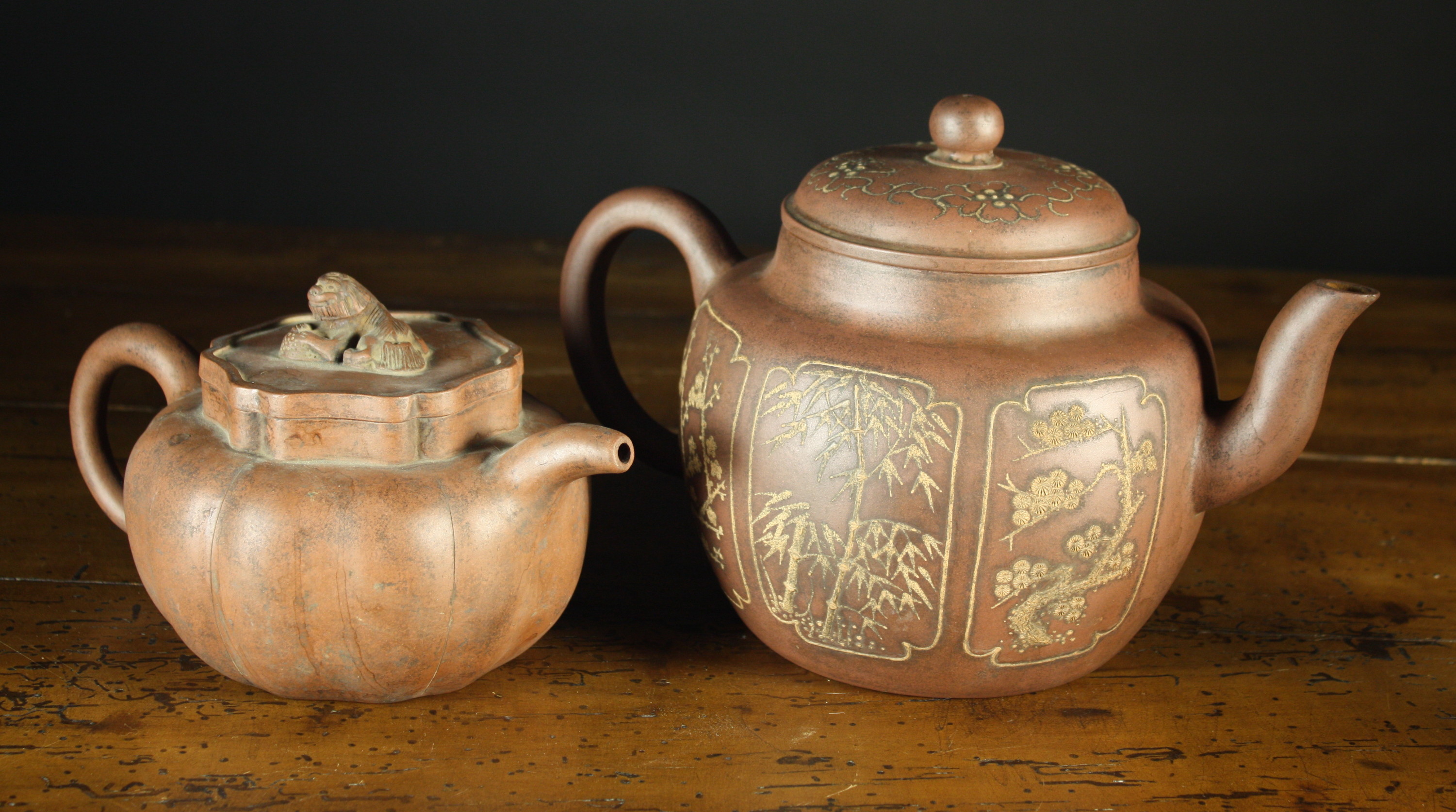 Two Large Yixing Earthenware Teapots.  One having a globular body decorated with panels of cedar,