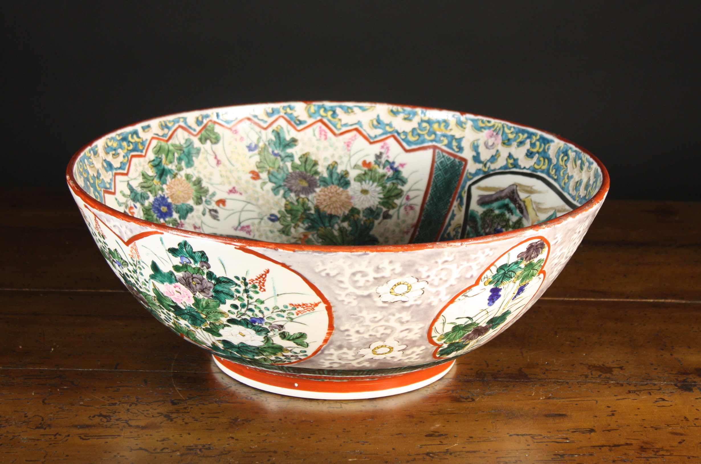 A Late 19th Century Oriental Punch Bowl, enamelled with panels of figures, landscape and flowers and