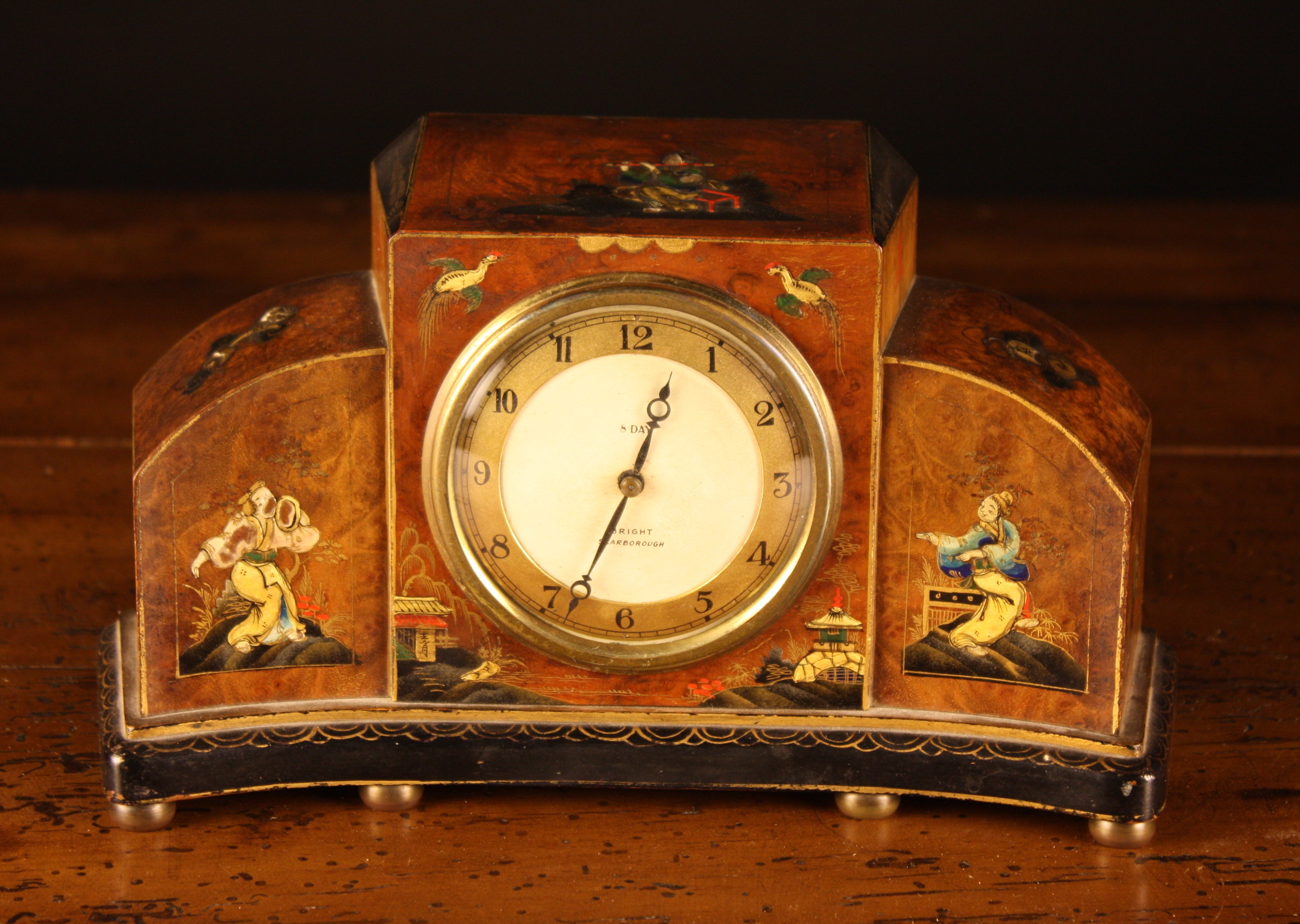 An Art Deco 8 Day Mantel Clock by Bright of Scarborough, in a curved burr walnut case decorated in