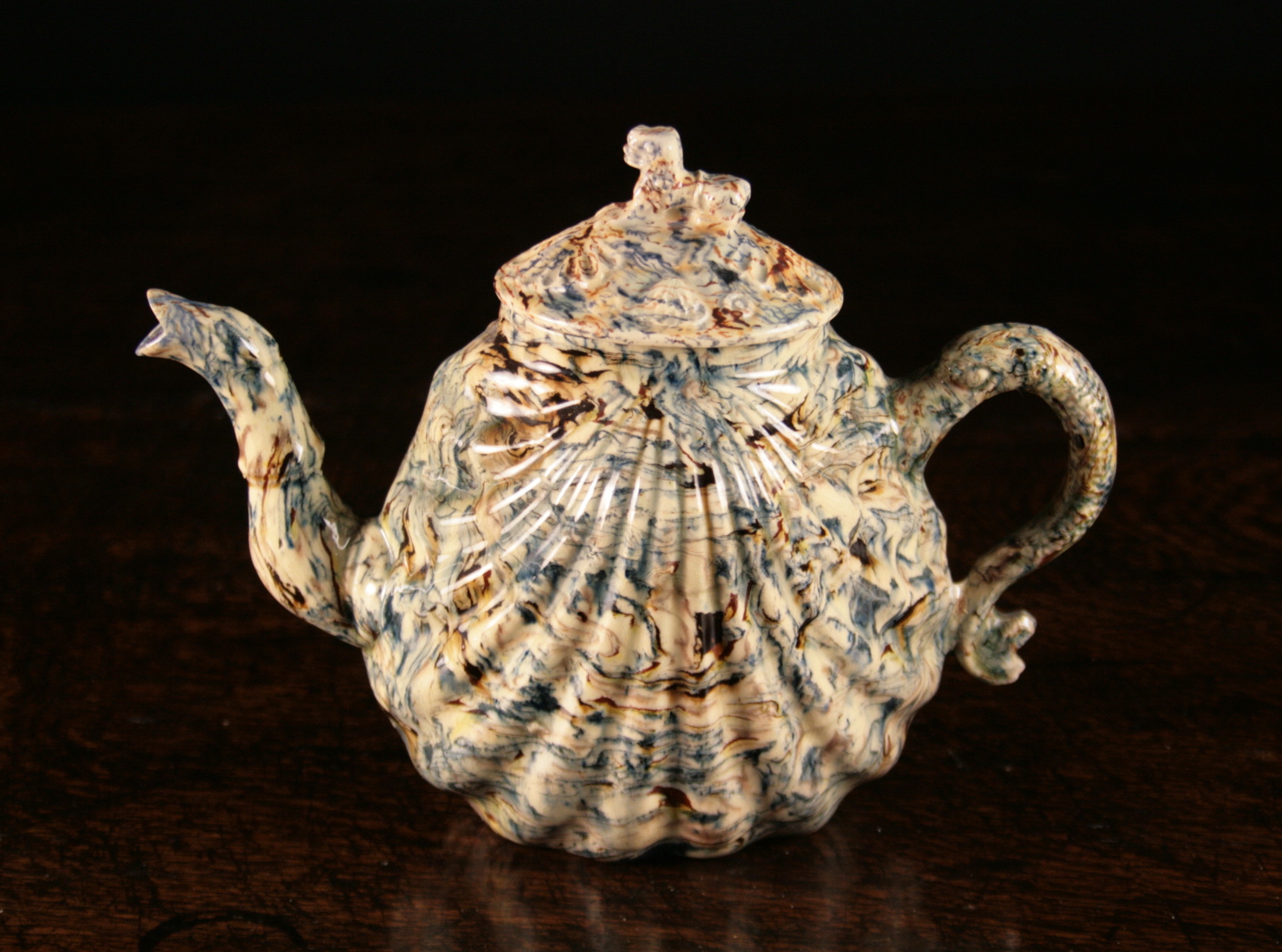 A Staffordshire Agateware Moulded Pecten-Shell Teapot, Circa 1750-60, 5½ ins (14 cms) in height.