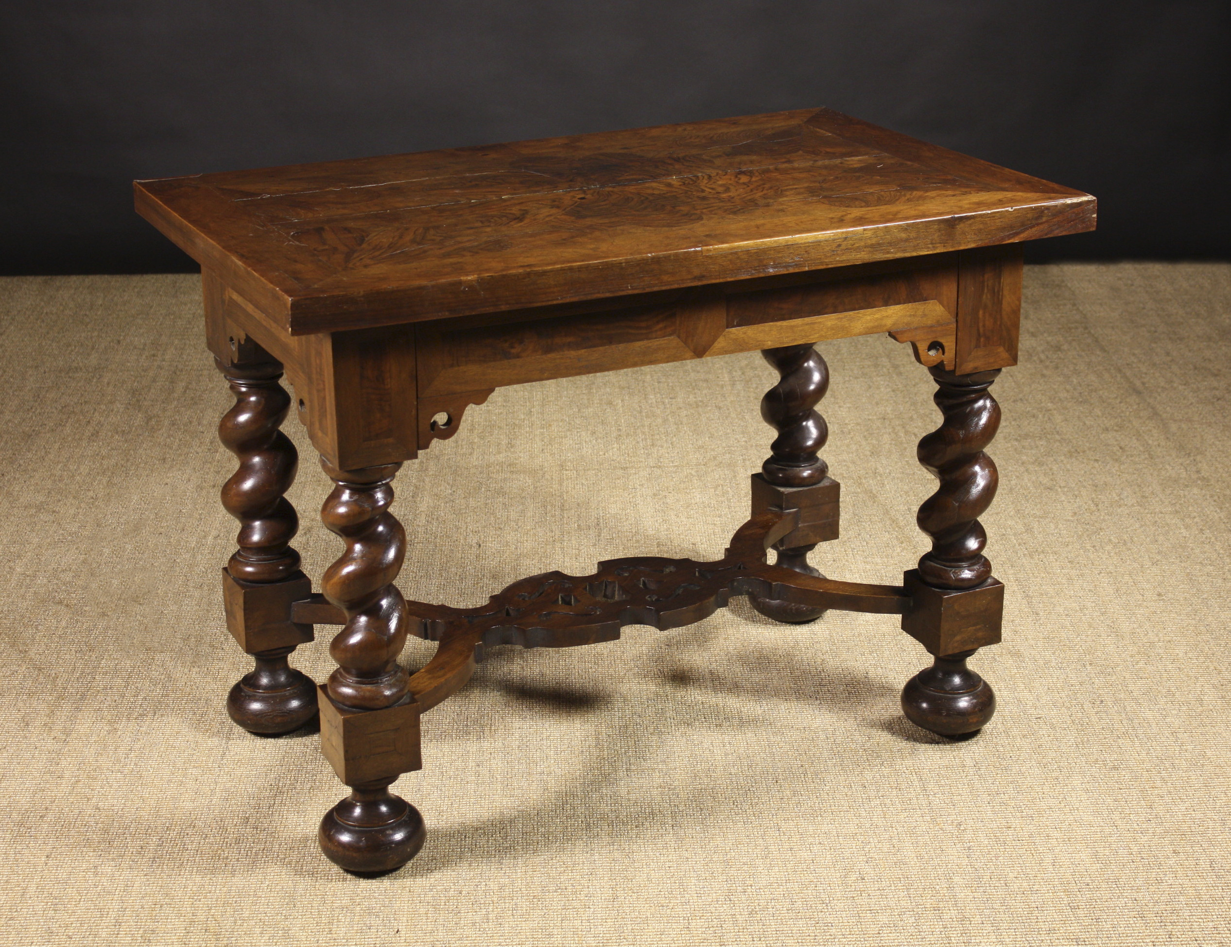 A Dutch Walnut Veneered Centre Table. The thick rectangular top veneered in petal segments and