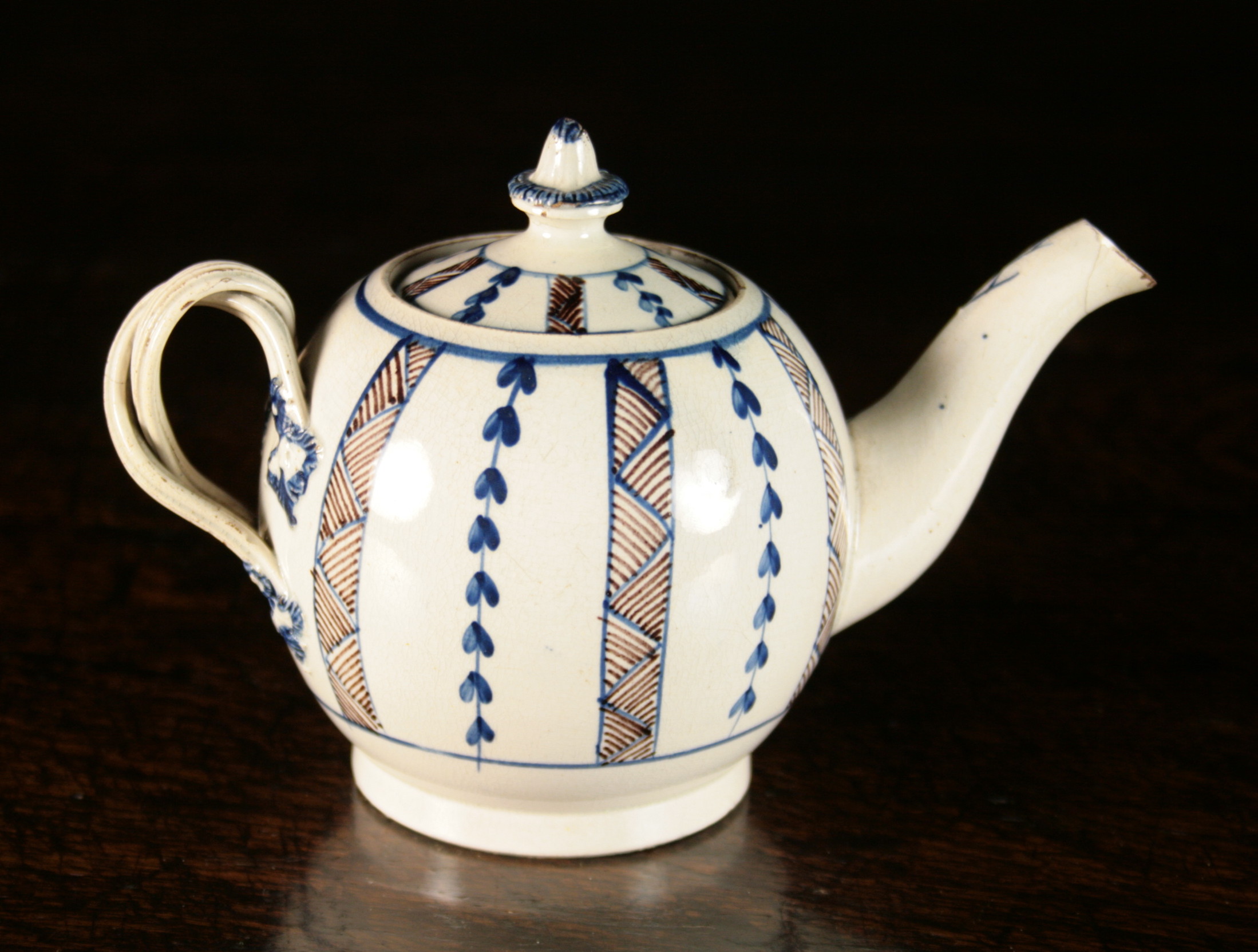 An 18th Century Pearlware Teapot, Circa 1770, probably Yorkshire origin. The globular body decorated