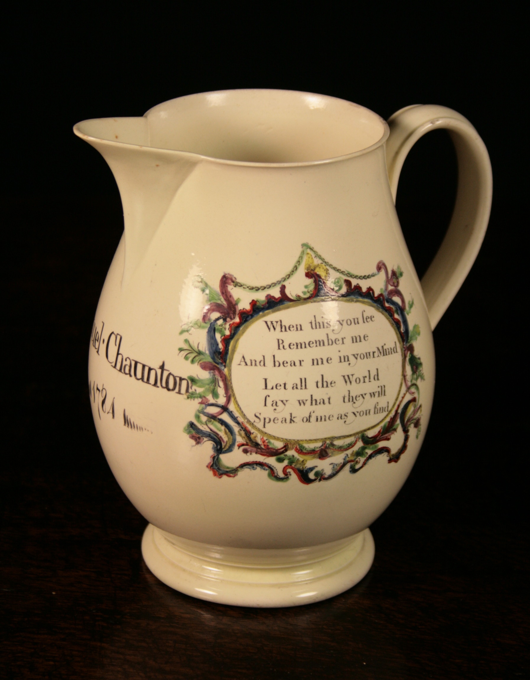 An 18th Century Creamware Jug hand inscribed Samuel Chaunton 1784, and having oval panels of verse