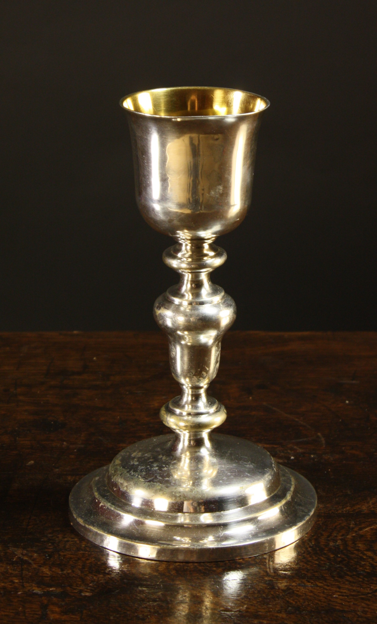 A Silver Chalice, possibly 17th century.  The flared bowl with gilt interior on an acorn knopped