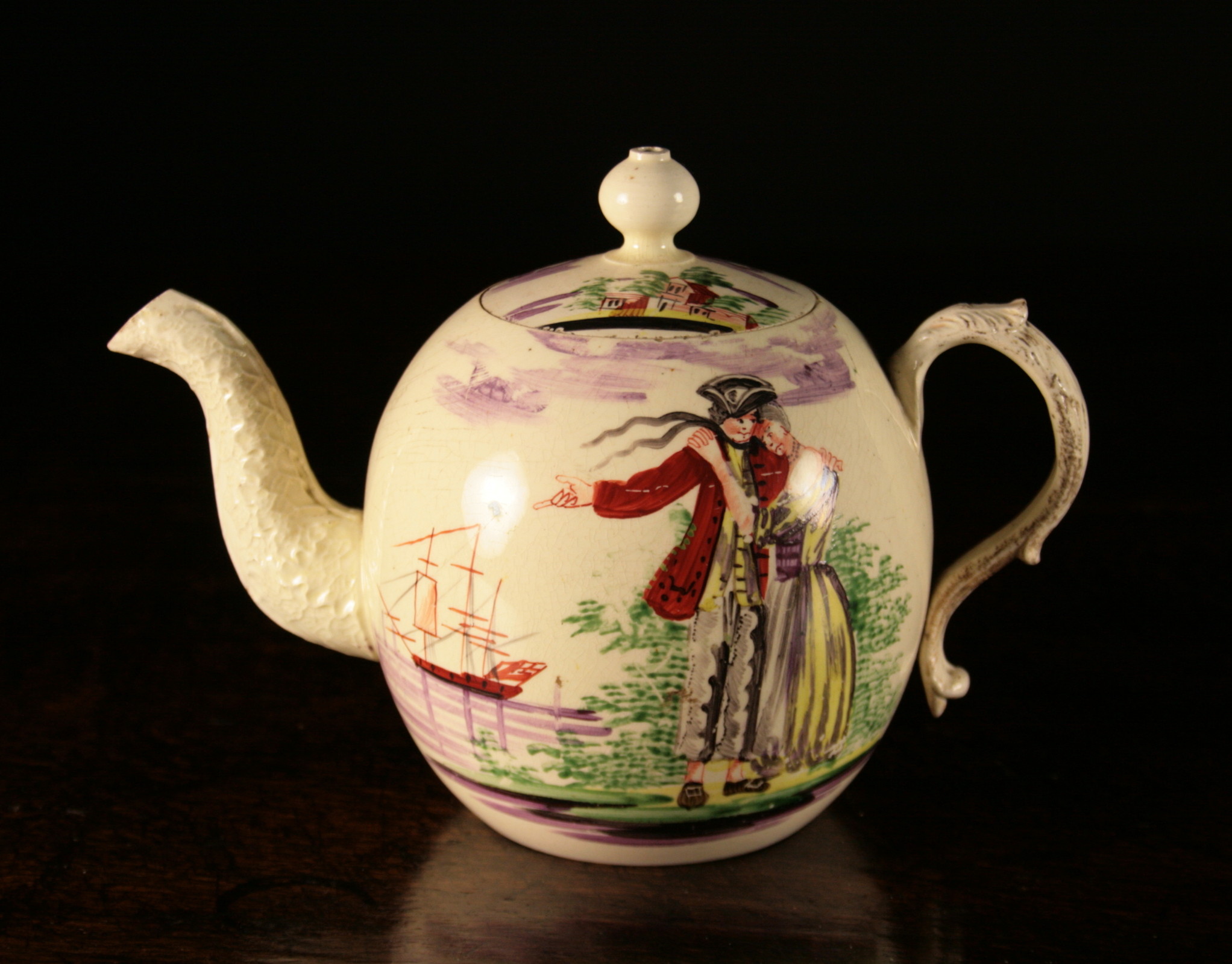 An 18th Century Creamware Teapot, Circa 1765-75, probably Wedgwood.  The globular body hand