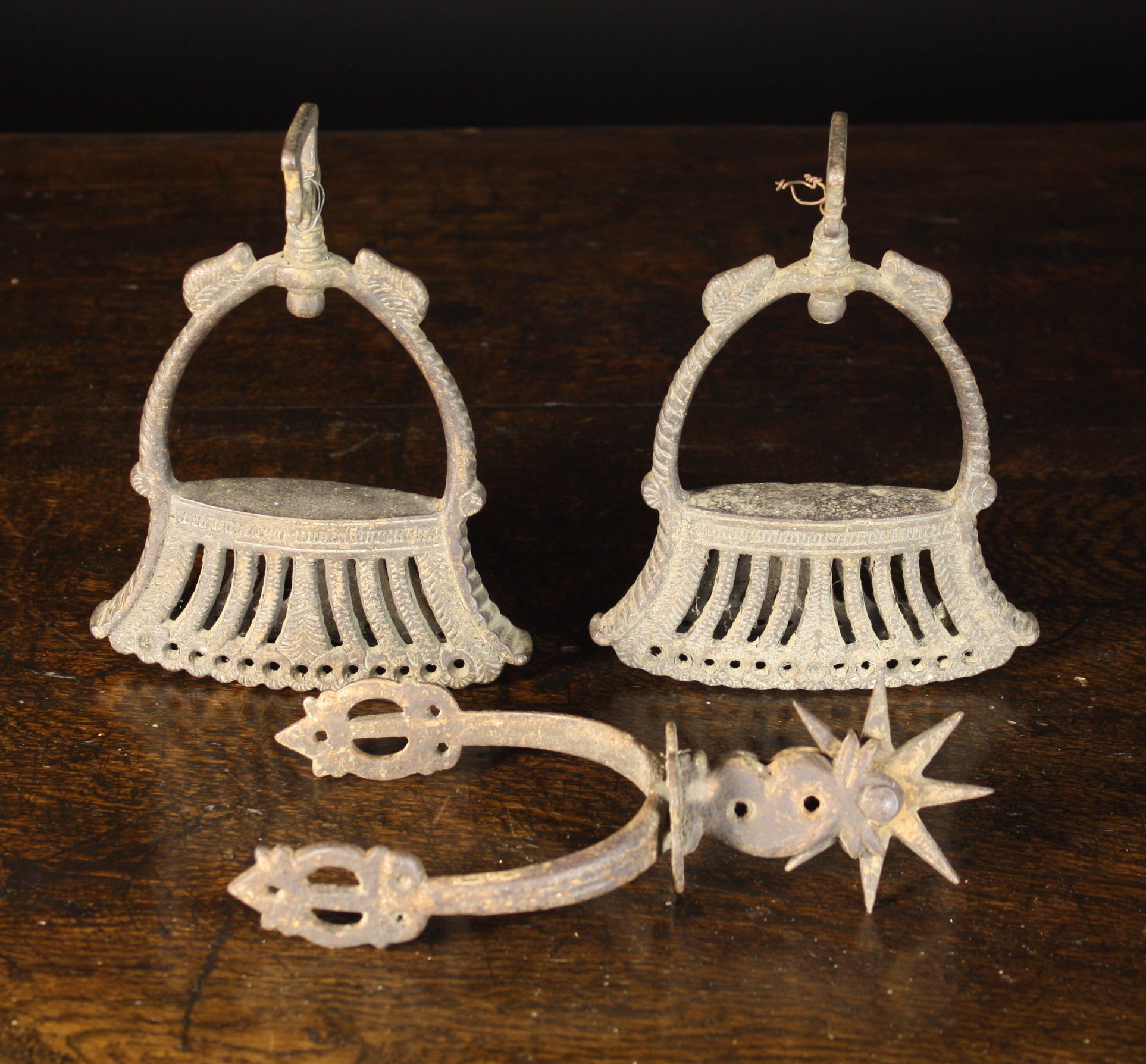 A Pair of Early Iron Stirrups with cast decoration and a spur with spiked roundel.