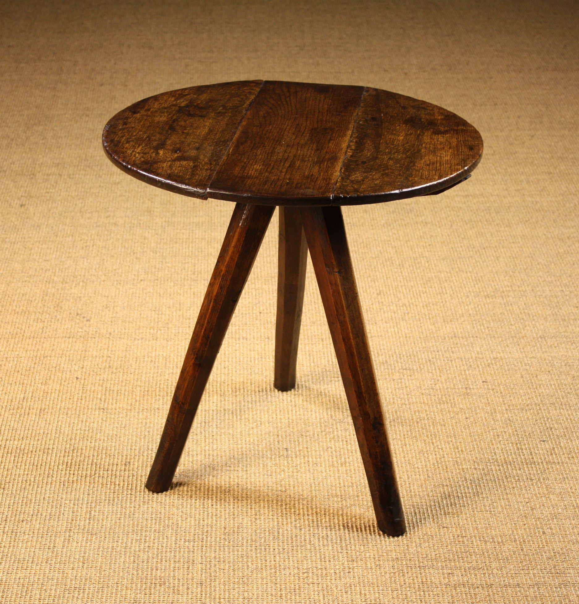 A Late 18th/Early 19th Century Oak Cricket Table standing on tapering chamfered legs, 21 ins (55