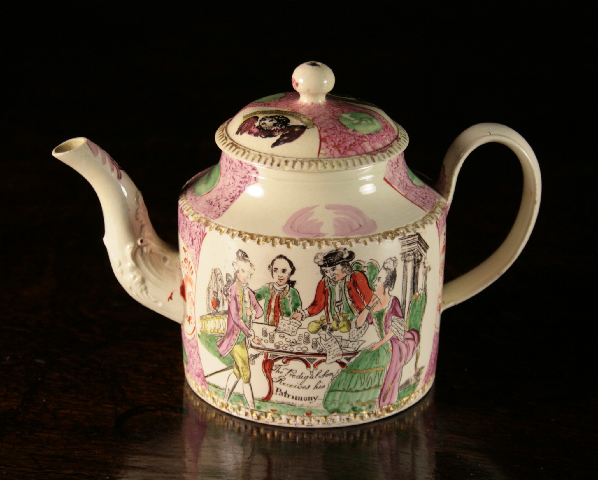 An 18th Century Leeds Creamware Teapot.  The cylindrical body decorated with 'The Prodigal Son