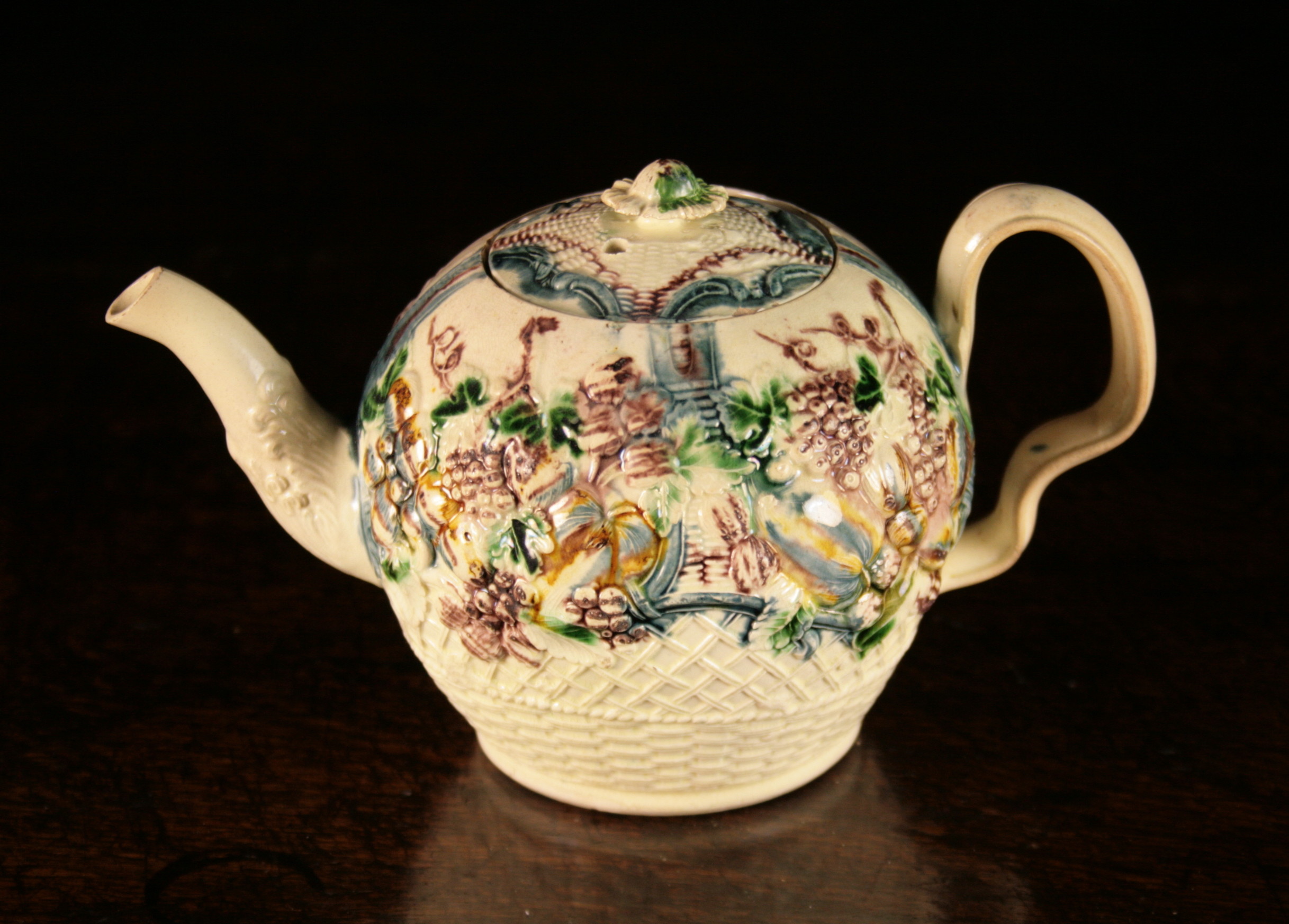 An 18th Century Creamware 'Fruit Basket' style Teapot by William Greatbatch.  The globular body