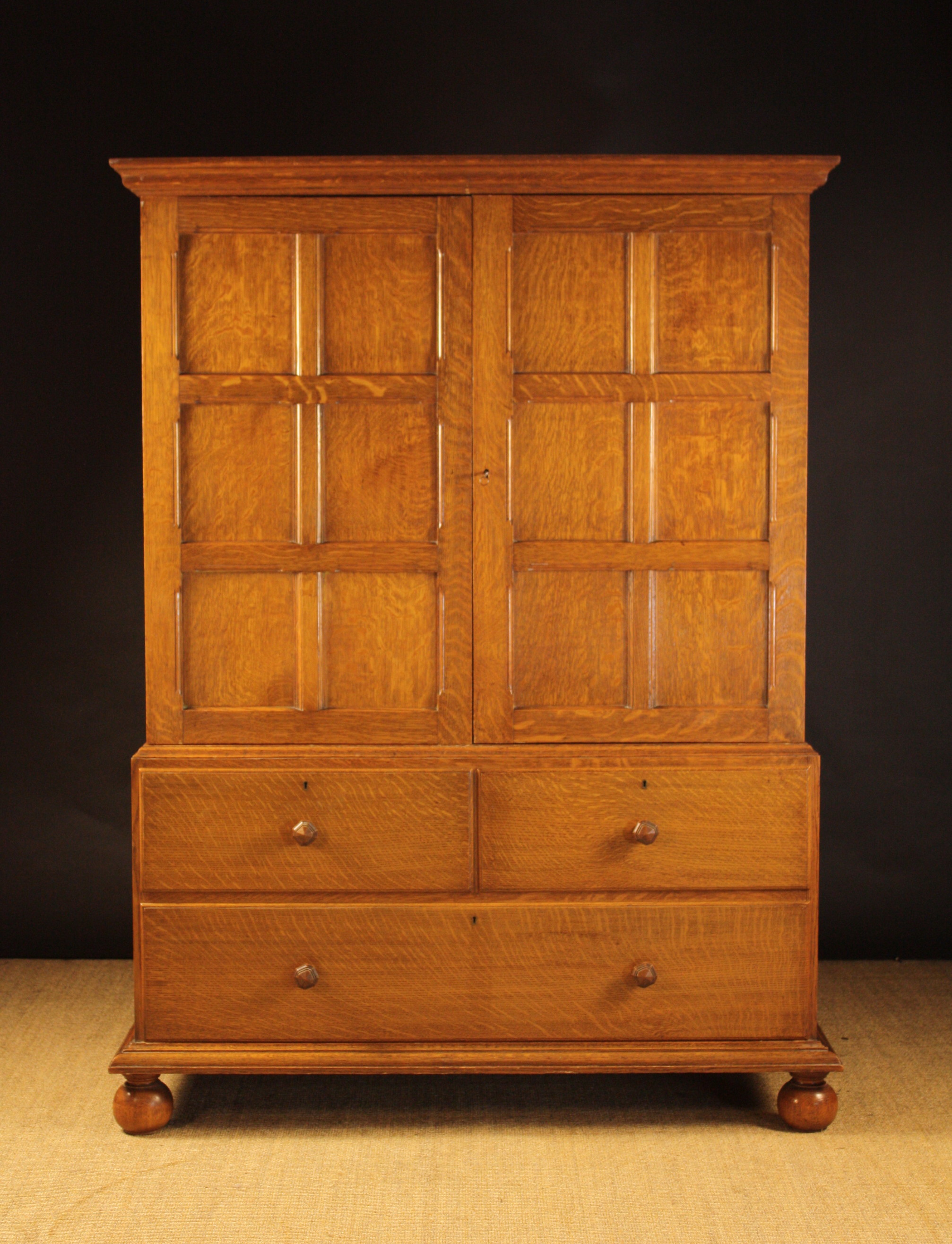 A Good Quality Oak Linen Cupboard.  The moulded cornice above two panelled doors enclosing linen