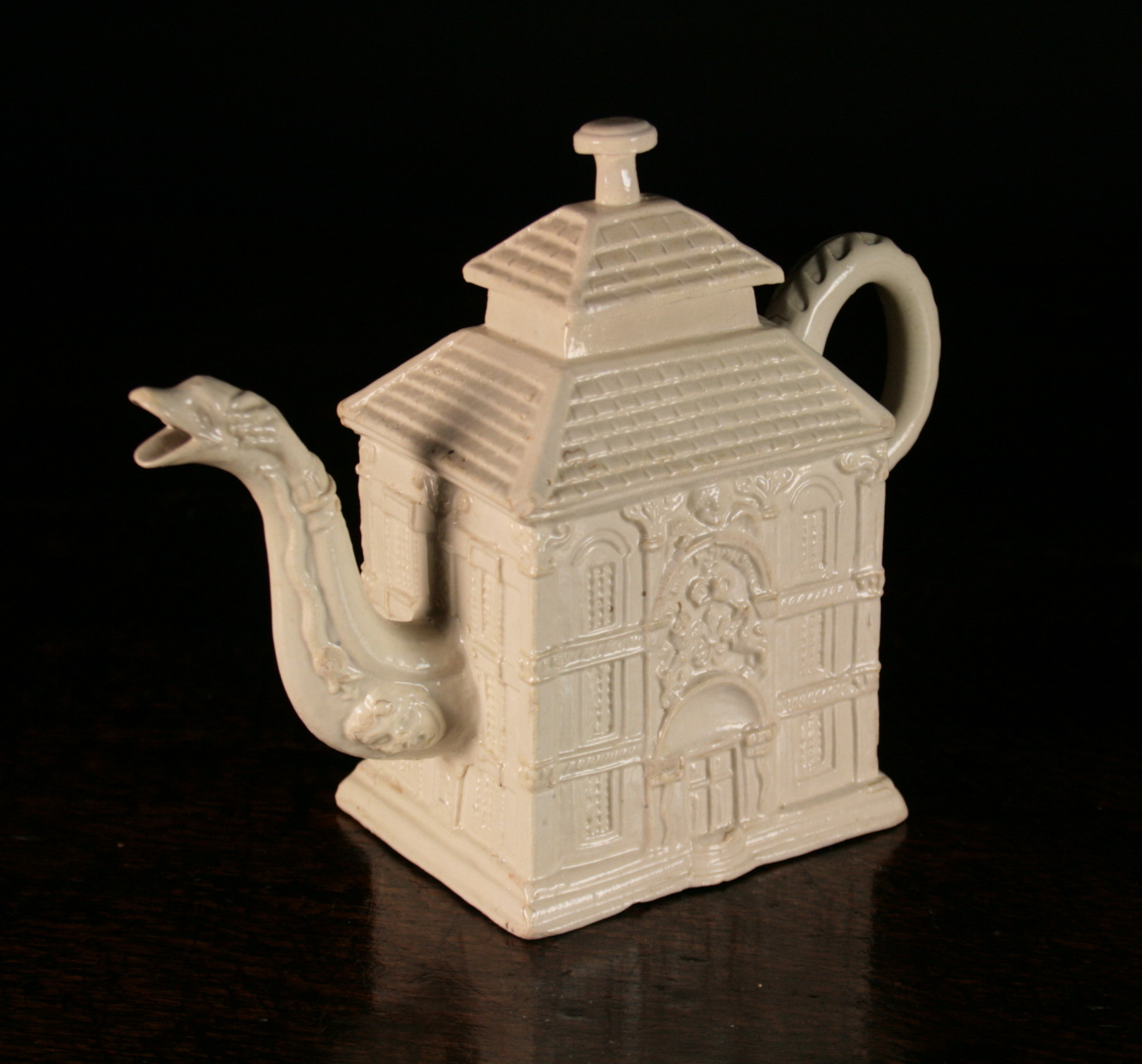 A Saltglazed Creamware Teapot modelled in the form of a house, 5¼ ins (13.5 cms) in height.