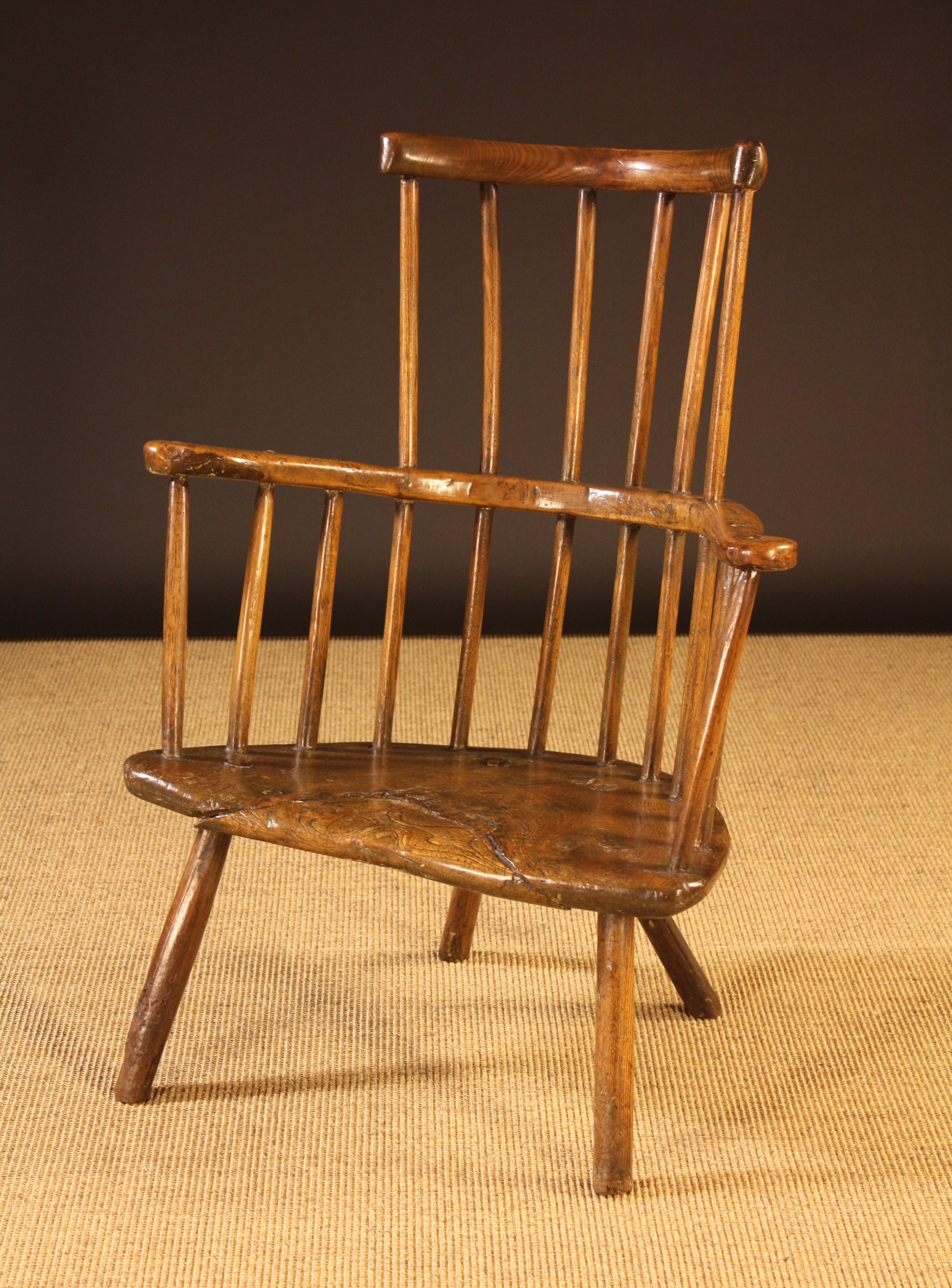 A Late 18th/Early 19th Century Primitive Ash Comb-back Windsor Armchair.  The curved top rail