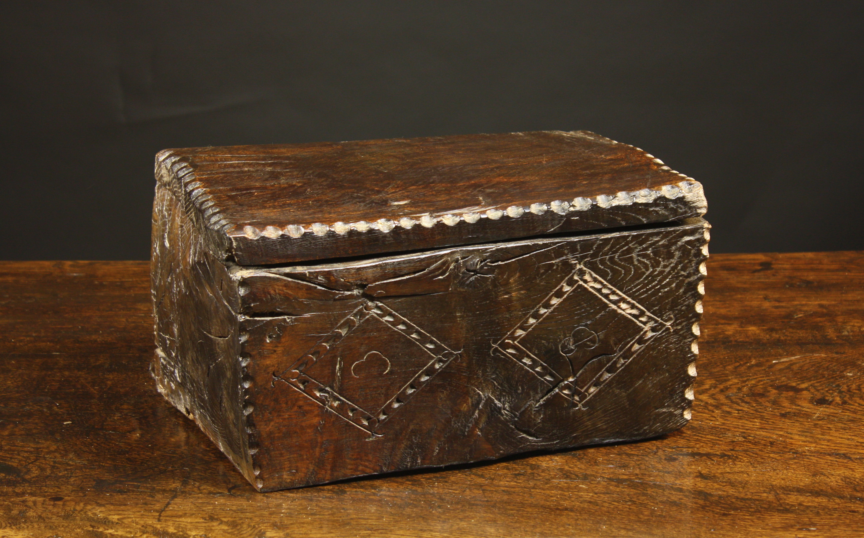 A Rare Oak Dug Out Box with Lozenge Carved Decoration. The lid  finely decorated with a chip