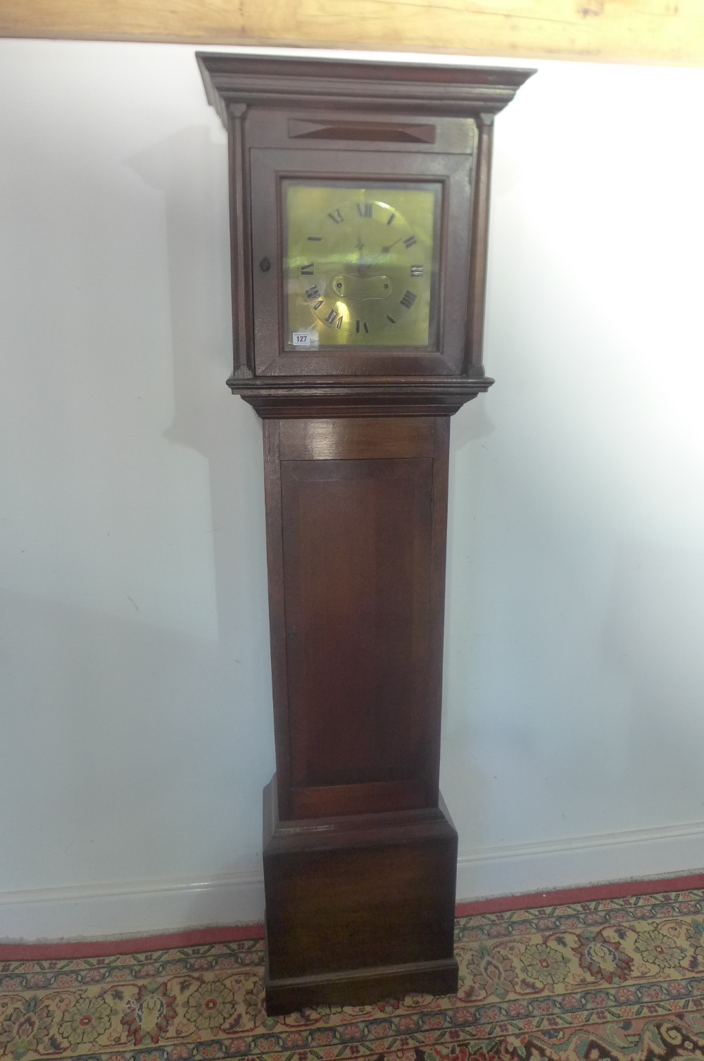 An oak longcase clock with a brass dial signed Upwood Ipswich" having a later wall clock movement