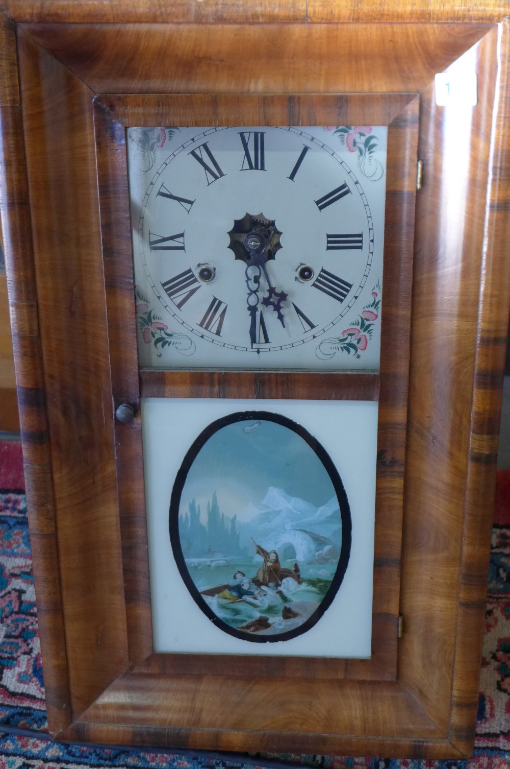 An American ogee walnut wall clock with a Arctic Exploration scene panel