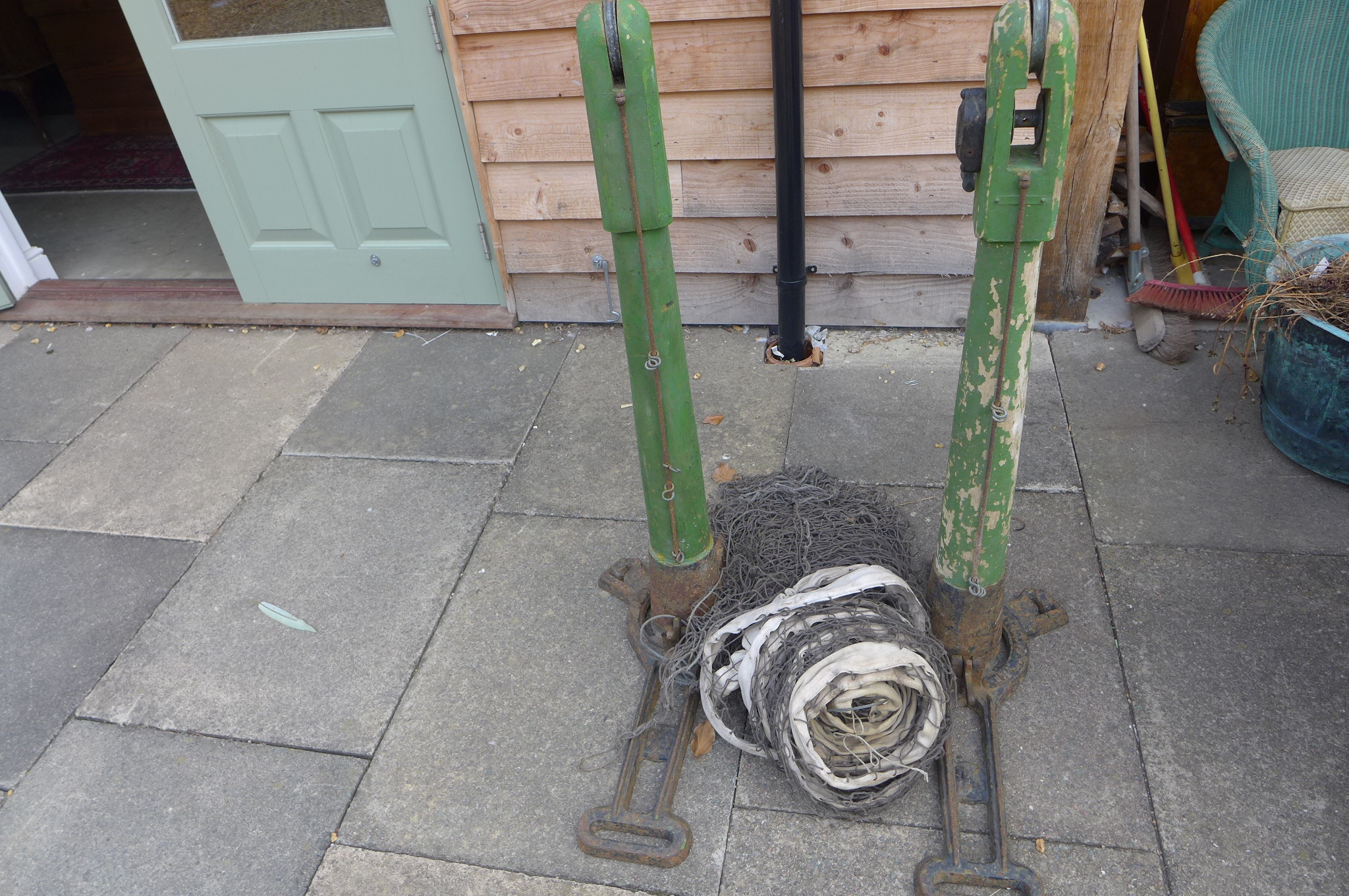 A pair of `Ladye Windsor` Tennis posts together with net made by B. Hirst and Sons