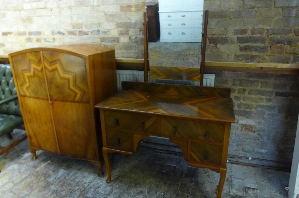 A walnut Art Deco wardrobe with a sunburst top and a dressing table with a mirror