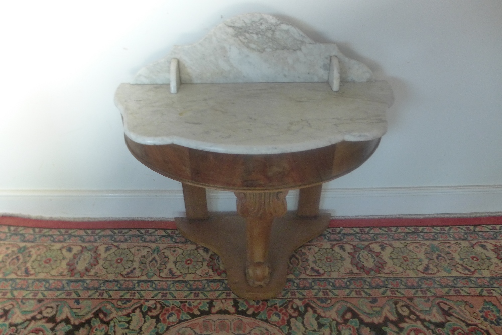 A 19th century washstand with a demi lune marble top