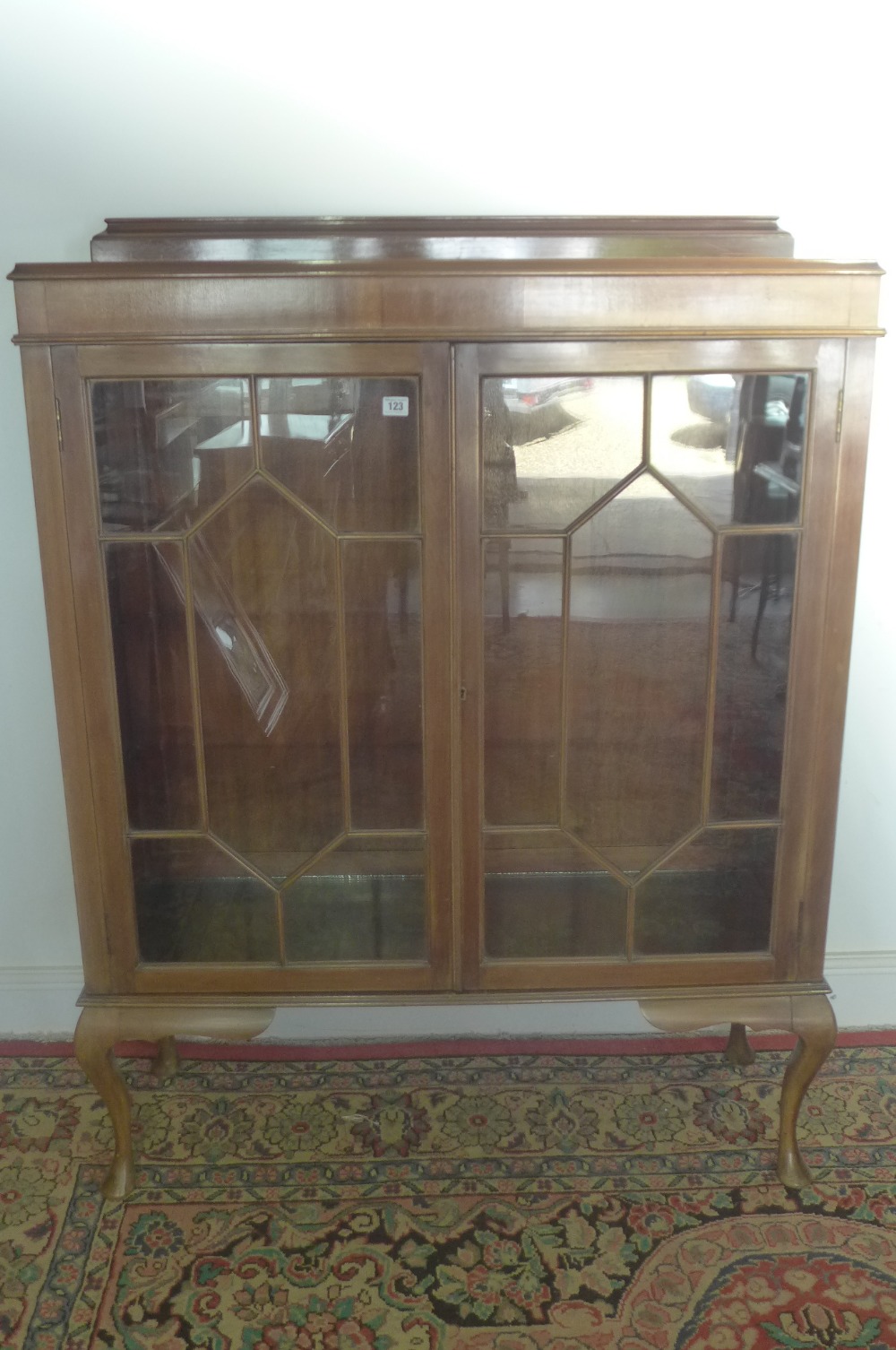 A 1930`s pale mahogany two door glazed display cabinet on cabriole legs 1.08m wide x 1.4m tall x