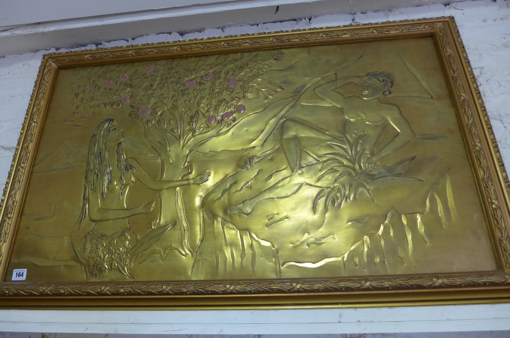 A gilt metal relief picture of Adam and Eve in a gilt frame - frame size 1.1m x 70cm