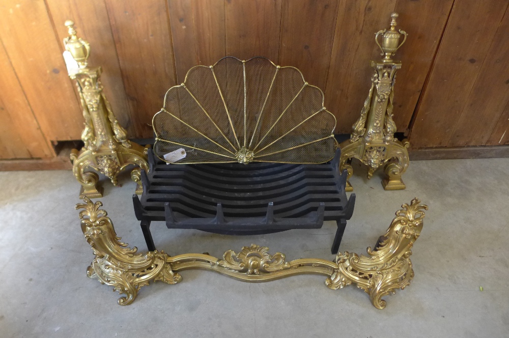 A late 19th century French polished brass adjustable fender, a fire grate and fan shaped guard