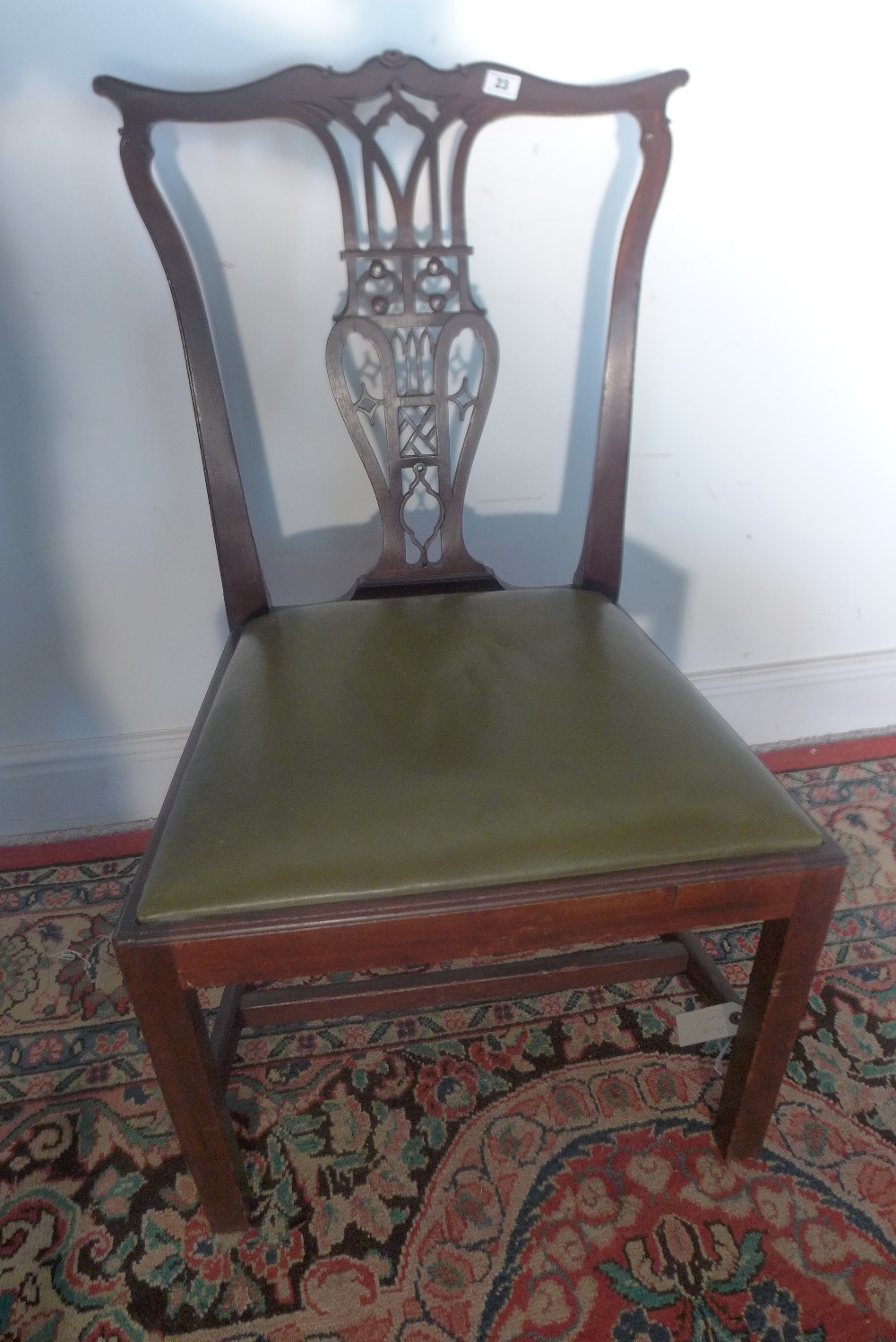 A mahogany Chippendale style chair upholstered in green leather