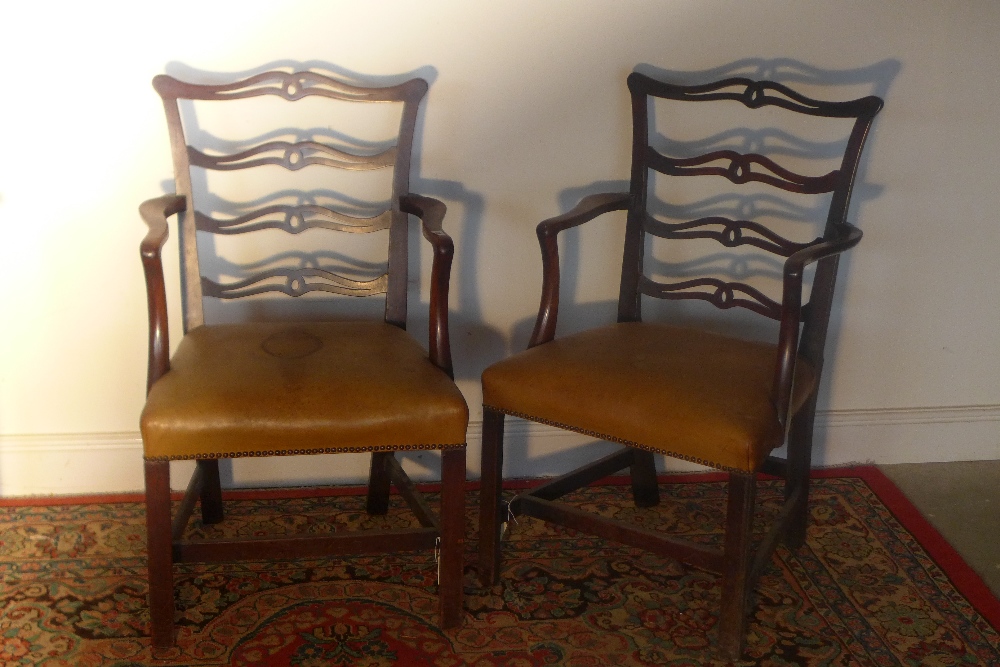 A pair of ladder back mahogany Chippendale style chairs upholstered in yellow leather (marked)