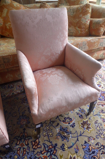 An Edwardian armchair covered in a pink fabric
