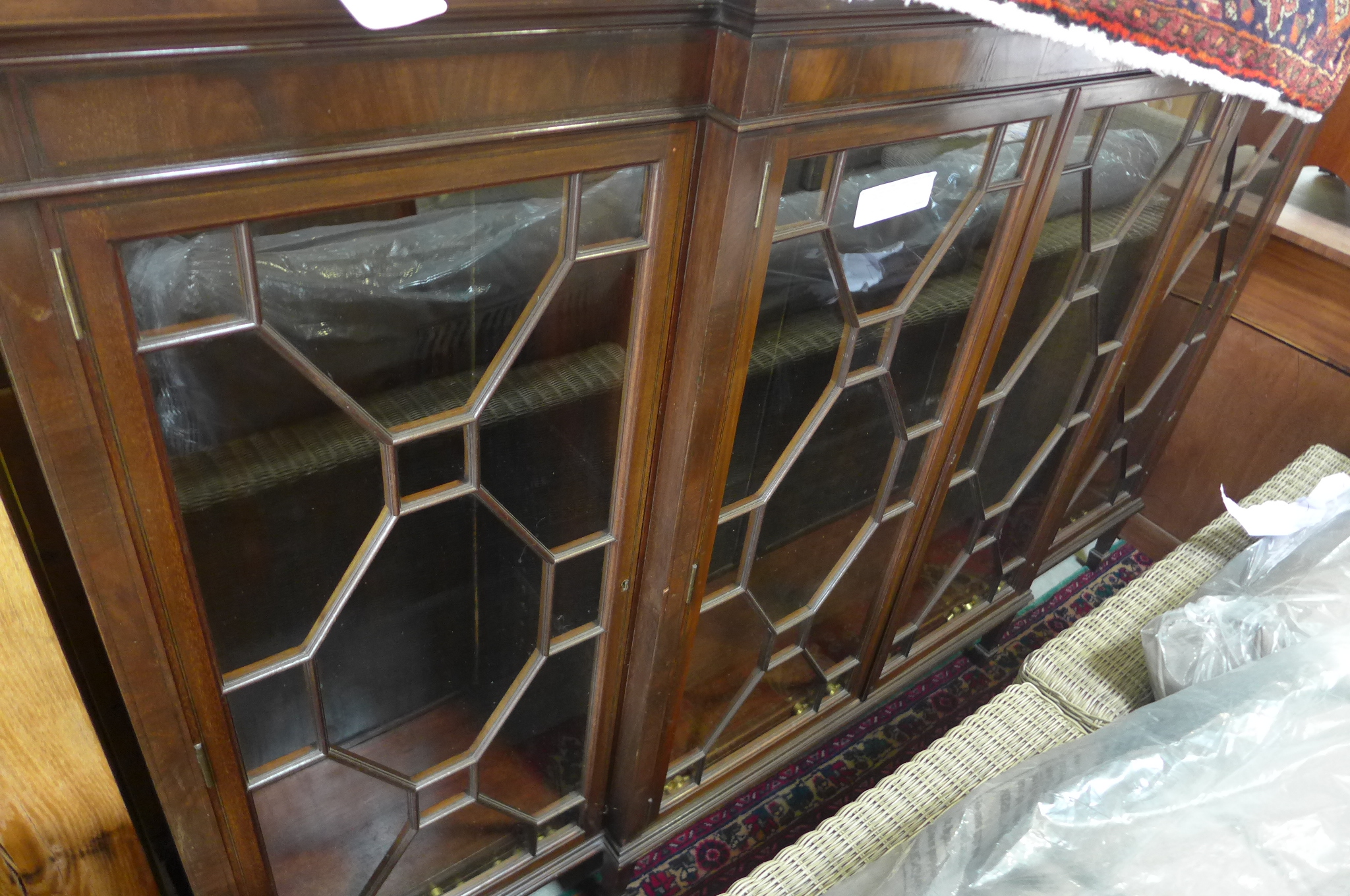 A mahogany breakfront glazed bookcase with four doors which are locked - no key - Height 132 cm x