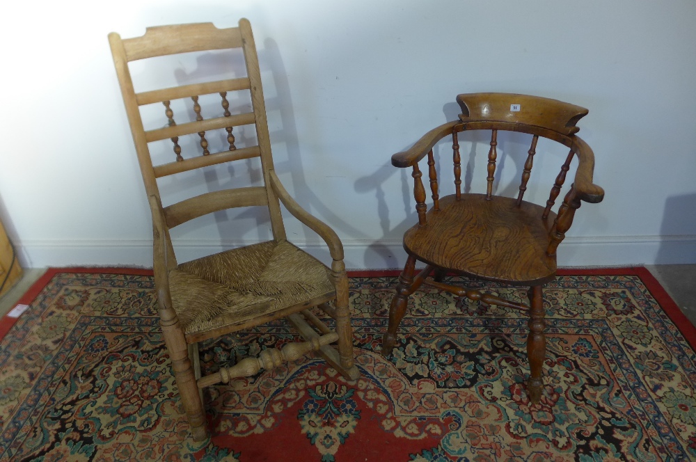 A 19th century smokers bow armchair with double stretcher and a ash rocking chair with a rush seat
