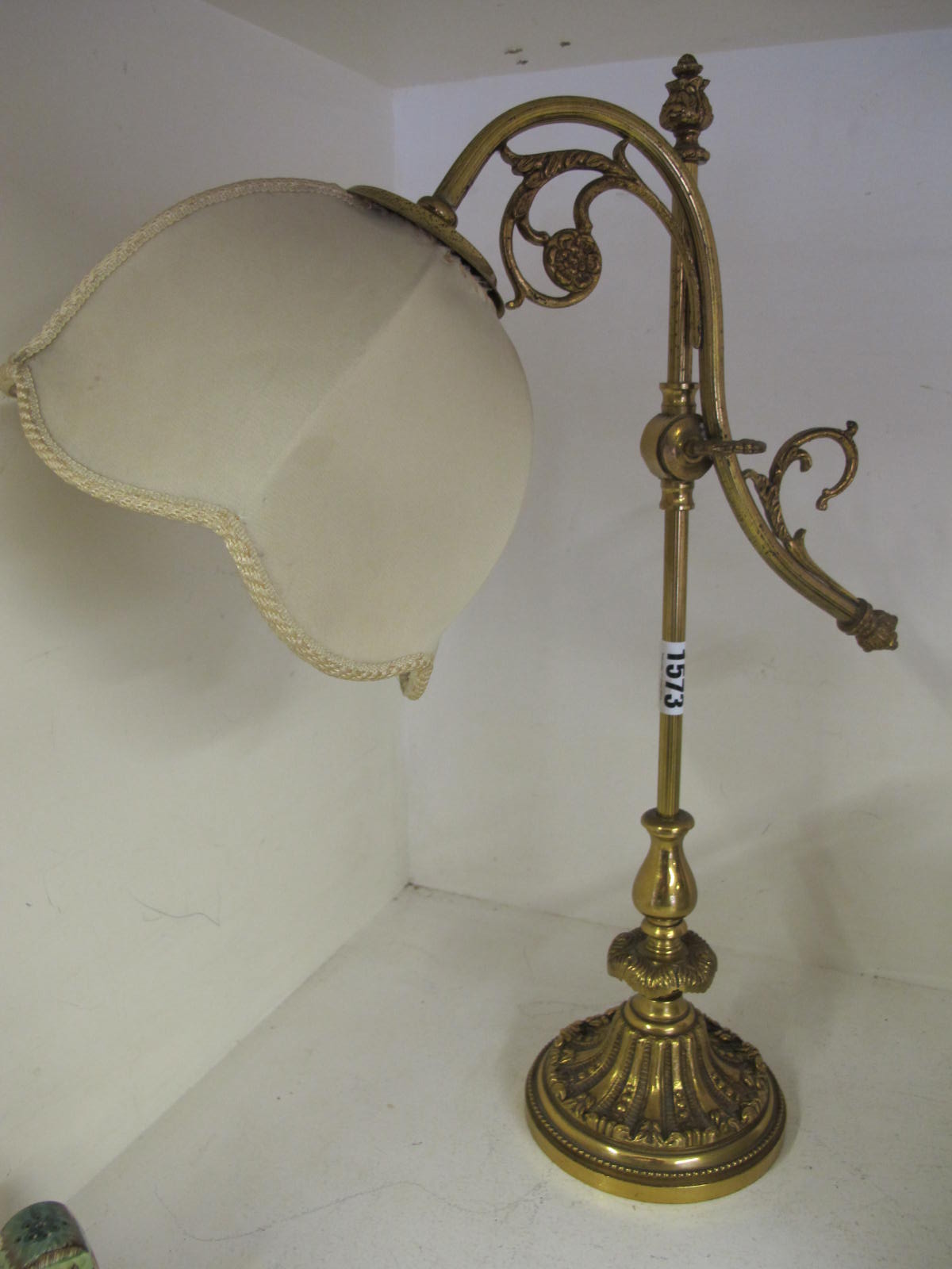 A vintage brass desk lamp and shade